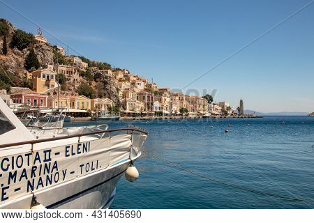 Symi, Greece - Jun 03, 2021. The Harbour Of Symi Town With The Districts Of Chorio And Gialos Is One