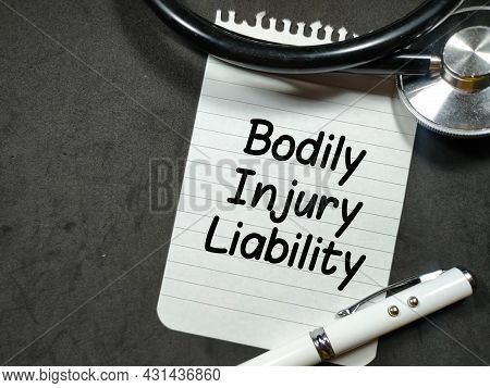 Medical Concept.text Bodily Injury Liability Writing On Notepaper With Pen And Stethoscope On Black 