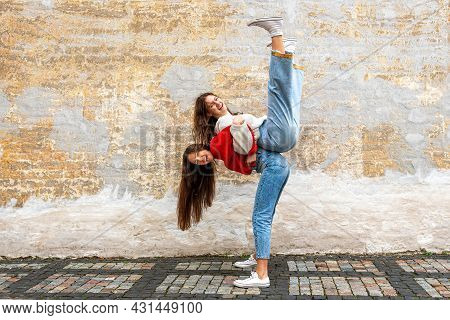 Funny Teenager Carrying Her Best Friend Piggyback On The Pavement At The Old Wall, Positive Emotions