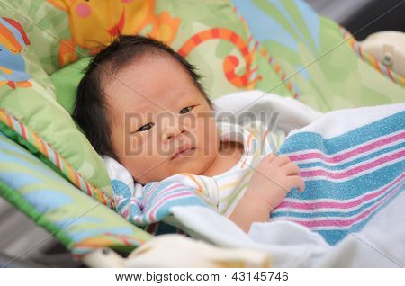 Baby boy on a bouncer seat