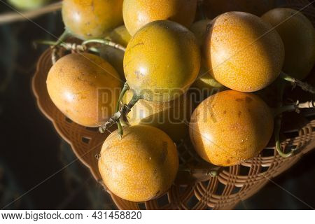 Yellow Passion Marquisa Fruits. The Bali Fruits, Indonesia. Asia Fruit In A Bowl On The Table Backgr