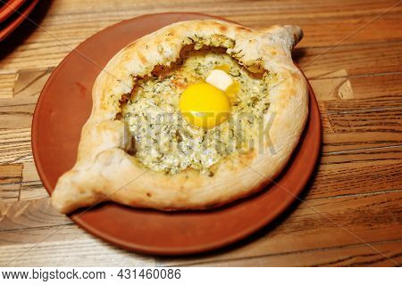 Khachapuri Made From A Delicious Tender Dough With Spinach, Melted Cheese And Butter Close Up. Tradi