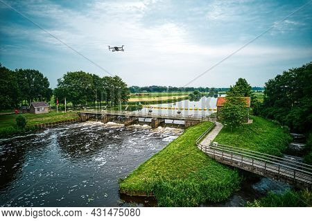 Water Swirls From The Weir In The River Vecht In The Netherlands. Downstream, Lock Keeper's House Ne