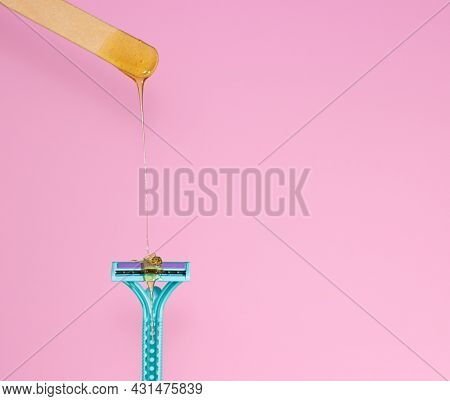 Sugar Paste For Hair Removal Against A Razor. Sugaring Paste Drips On A Razor On A Pink Background, 