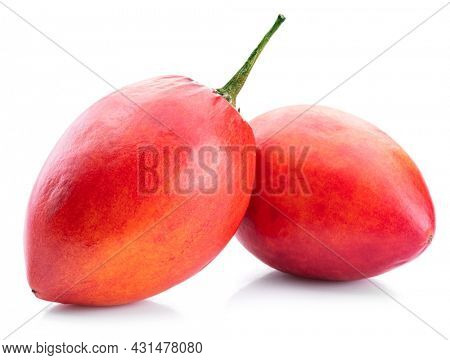 Two ripe tamarillo fruits isolated on a white background.