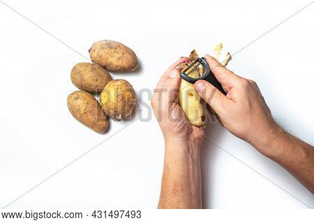 The Guy Peels Potatoes On A White Background, In The Hands Of A Rotten Potato