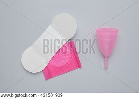 Menstrual Cup And Disposable Pantyliners On Grey Background, Flat Lay