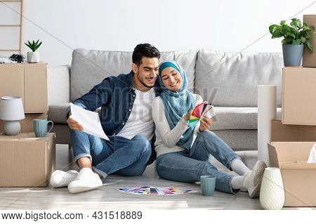 Happy Middle-eastern Family Working On Interior For Their New House