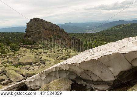 Large Kurum Stones Lie In The Forest In The Mountains, Stones Covered With Moss, Against The Backgro