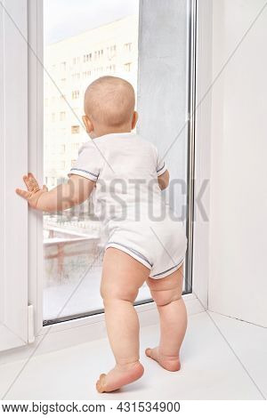 Cute Small Boy At House. Childhood Concept. Light Background. Smiling Child. Happy Emotion. Copyspac