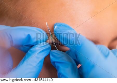 Man With Pierced Eyebrow. Three Small Black Piercings.