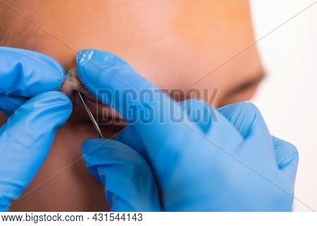 Man With Pierced Eyebrow. Three Small Black Piercings.