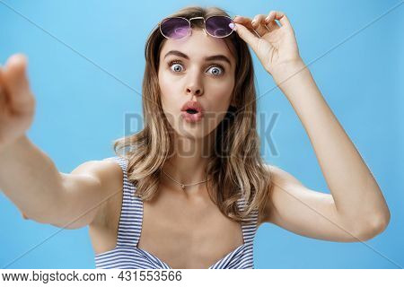 Woman Taking Off Glasses While Looking At Herself In Frontal Camera Of Smartphone Holding Cellphone 