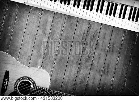 Musical Instrument - Sloseup Midi Piano 61 Key Keyboard And Acoustic Guitar On A Wooden Background M
