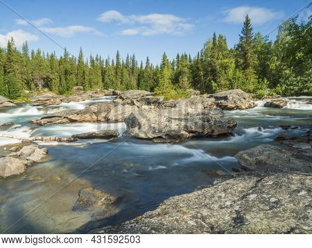 Beautiful Landscape With Long Exposure Water Stream And Cascade Of River Kamajokk, Boulders And Spru
