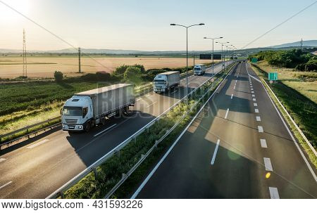 Transportation Trucks In Line On A Country Highway