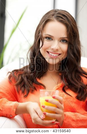 jeune femme tenant le verre de jus d'orange