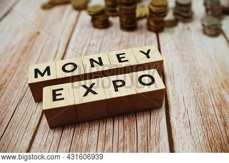 Monney Expo Alphabet Letter And Coins On Wooden Background