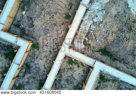 Top Down Aerial View Of Building Works Of New House Concrete Foundation On Construction Site.