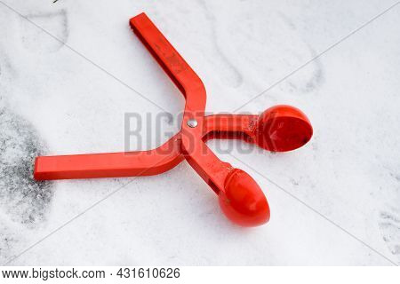 Bright Red Plastic Device, Toy Clip For Making Snowballs On White Snow Background. Happy Childhood A