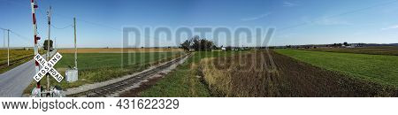 Panorama Of Farm Countryside With One Lonely Rail Road Track Running Thru It