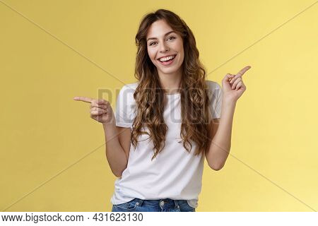 Girl Have Two Suggestions Pointing Sideways. Cheerful Charismatic Curly-haired Attractive Woman Poin