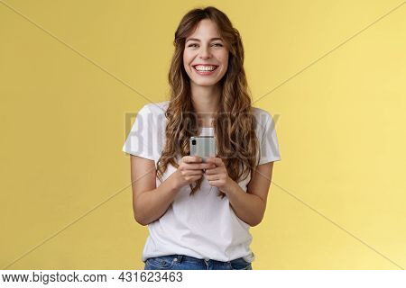 Cheerful Carefree Happy Lively Girl Hold Smartphone Using Awesome Funny App Playing Cool Game Relaxi