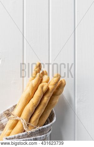 Grissini sticks. Traditional italian bread sticks on white table. Top view.