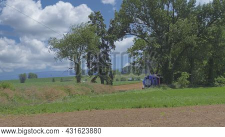 Ronks, Pennsylvania, June 2019 - Thomas The Tank Engine Approaching Thru Trees And Farmlands Pulling