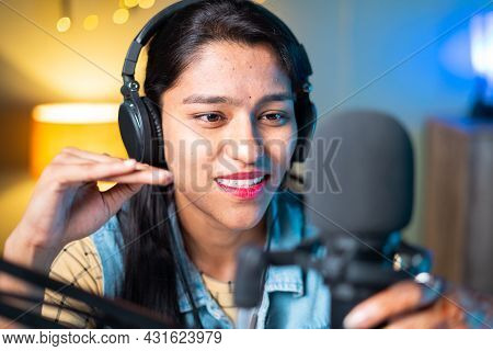 Close Up Head Shot Of Happy Cheerful Young Girl Podcasting By Looking Camera - Concept Of Broadcatin