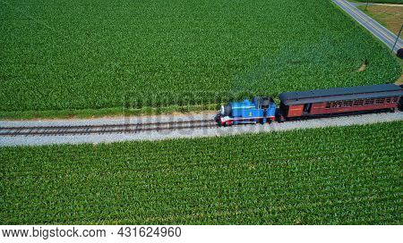 Ronks, Pennsylvania,june 2019 - Aerial View Of Thomas The Tank Engine Approaching Thru Trees And Far