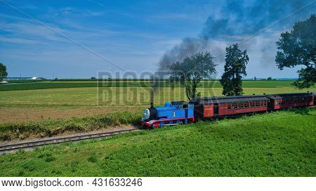 Ronks, Pennsylvania,june 2019 - Aerial View Of Thomas The Tank Engine Approaching Thru Trees And Far