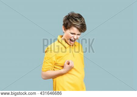 Caucasian Boy Shouting With Happiness On Blue Background