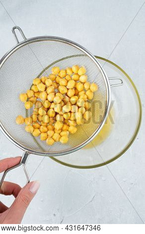 Chickpea Water Aquafaba. Egg Replacement. Vegan Concept. Metal Sieve Draining Aquafaba Chickpea Wate
