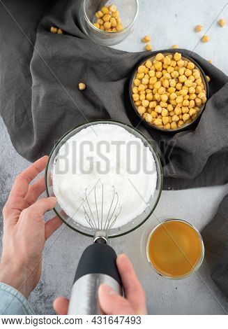 Chickpea Aquafaba. Egg Replacement. Vegan Cooking Concept. Men Hands Whippe Whisk Chickpeas Liquid I