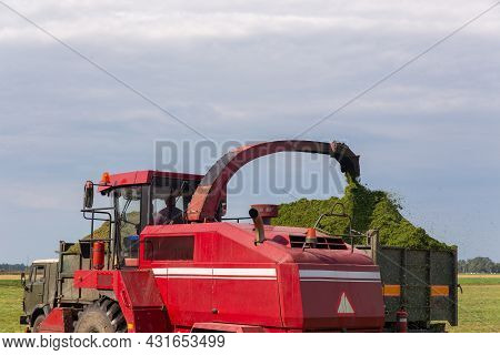 Combine Harvesting A Green Field