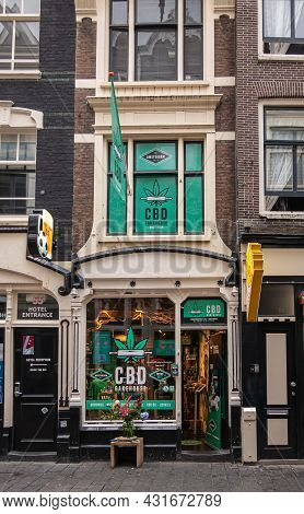 Amsterdam, Netherlands - August 14, 2021: Warmoesstraat. Cbd Cannabis Bakehouse Advertises Its Produ