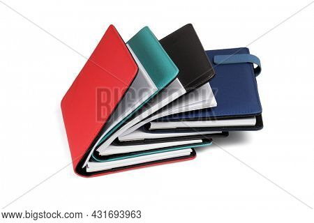 Pile of Colourful Interleaved Dairies on White Background
