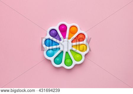 Presses With A Finger Anti-stress Toy Pop It On Pink Background. Colorful Silicone Poppit Toy, Bubbl