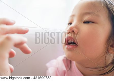 Adorable Asian Girl Kid Getting Swab Test At Home By Her Parent. Rapid Self Test For Covid-19, Antig