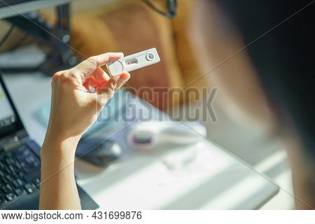 Shot From Behind Of People Holding Sars 2019-ncov Covid-19 Antigen Rapid Test Kit With Appear Positi