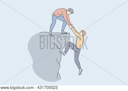 Helping Hand And Assistance Concept. Young Man Standing On Peak Of Rock Giving Hand To Help His Frie