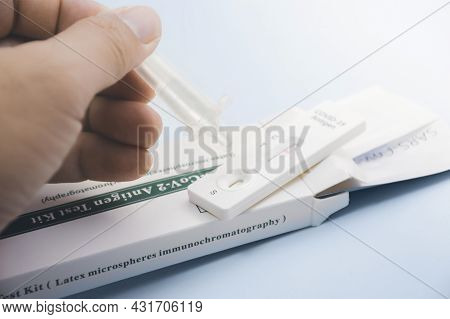 Own Hand Placing The Secretions Sample Into The Sars Cov-2 Rapid Antigen Test Kit (atk) With The Ext