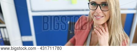Young Beautiful Woman Sitting At Table In Office