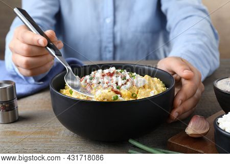 Woman Eating Traditional Banosh At Wooden Table, Closeup