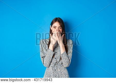 Cheerful Caucasina Girl In Dress Laughing And Having Fun, Covering Mouth With Hands And Chuckle Over