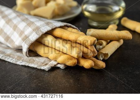 Grissini sticks. Traditional italian bread sticks on black table.
