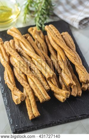 Grissini sticks. Traditional italian bread sticks on cutting board.