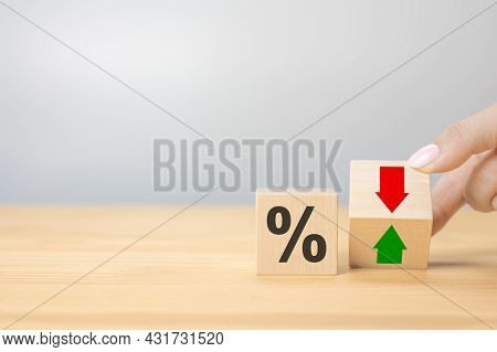 Hand Flip Wood Cube Change Arrow Down To Up. Changes In Interest Rates. Hand Is Turning A Dice And C