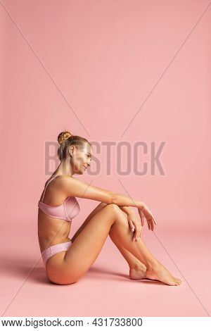 Cropped Vertical Portrait Of Young Female Model Posing Issolated Over Pink Studio Background